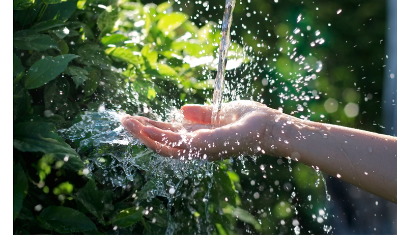 photo of water falling on someone's hand